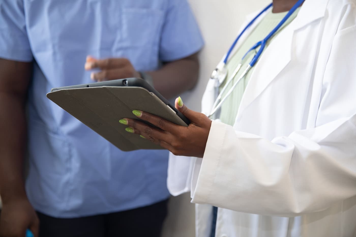 Doctor showing a patient information on a tablet during a consultation
